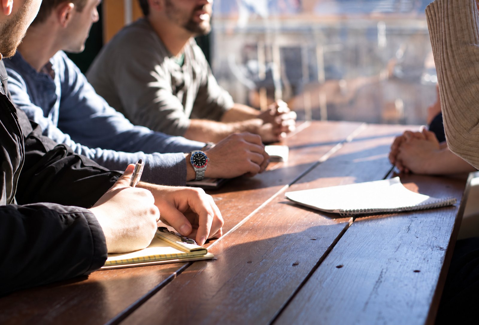 Team taking notes around a table